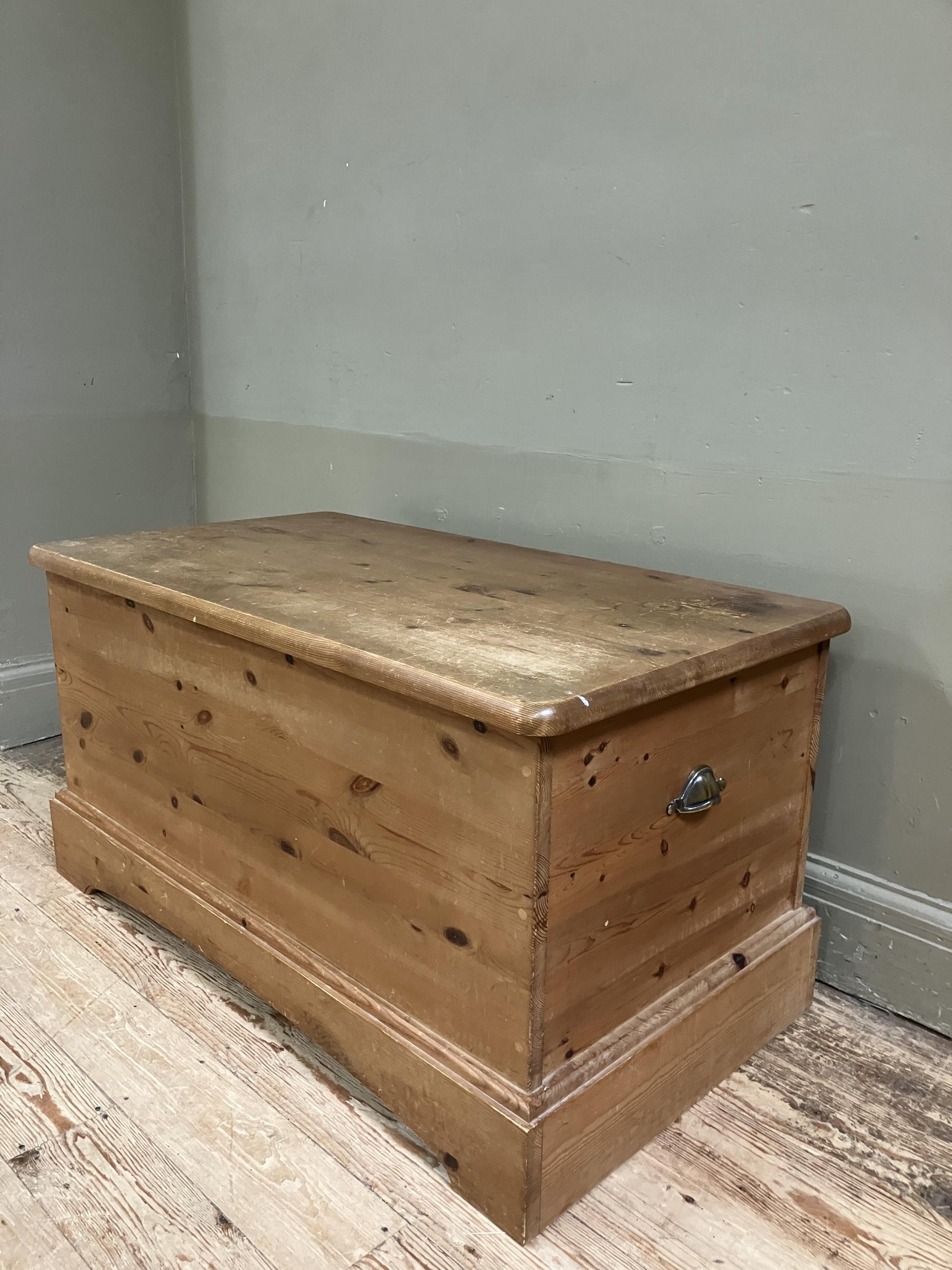 A modern pine blanket chest with brass cup handles and on plinth base, 97cm x 53cm x 50cm - Image 2 of 3