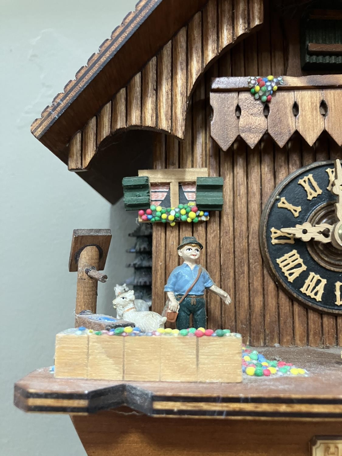 A Black Forest style cuckoo clock with swinging pendulum and weights having two figures , goats - Image 4 of 5