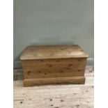 A modern pine blanket chest with brass cup handles and on plinth base, 97cm x 53cm x 50cm