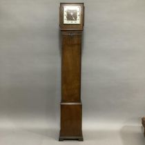 A 1930s oak cased grandmother clock, the square silvered chaptering with black Arabic numerals,