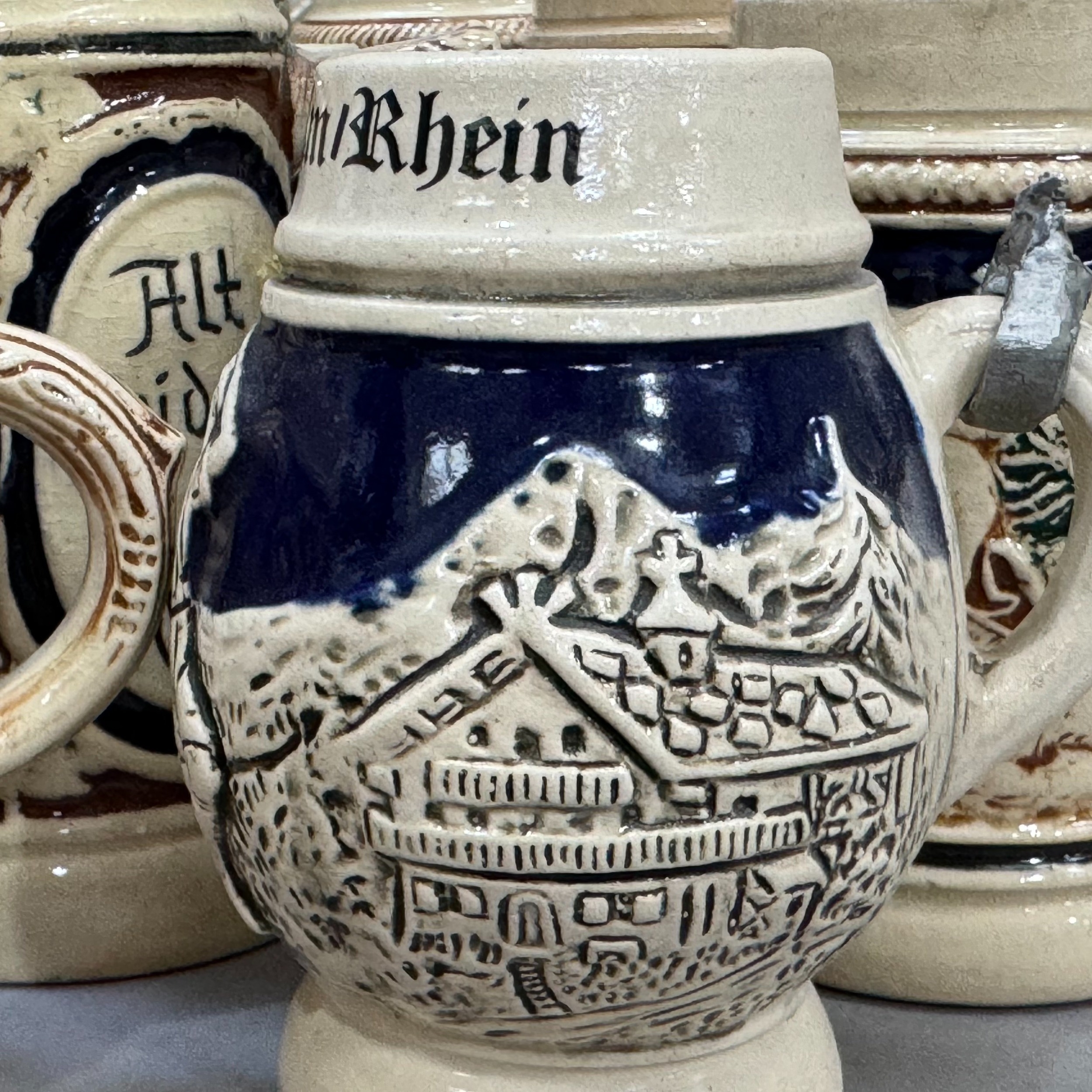 A large quantity of German pottery steins glazed in blue and with relief moulded scenes - Image 3 of 3