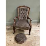 A late Victorian open armchair having an encircling frame with shell cresting, button upholstered