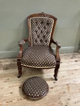 A late Victorian open armchair having an encircling frame with shell cresting, button upholstered