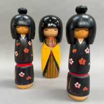 A Japanese Kookeshi doll, hand painted body in yellow and stripes, 22cm high, together with a