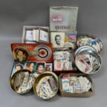 A collection of cigarette and trade cards contained in various printed tins together with movie star