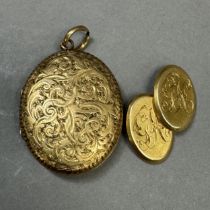 A Victorian oval locket in 9ct gold, foliate scroll engraved with vacant shielded shaped