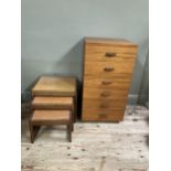 A teak chest of six drawers with bar handles, 50cm x 46cm x 94cm together with a nest of three