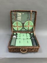 A vintage wicker picnic hamper by Sirram, circa 1950/60s fitted with six knives, forks and