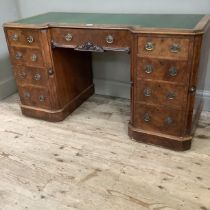 A Victorian figured walnut desk converted from a dressing table having a faux leather writing