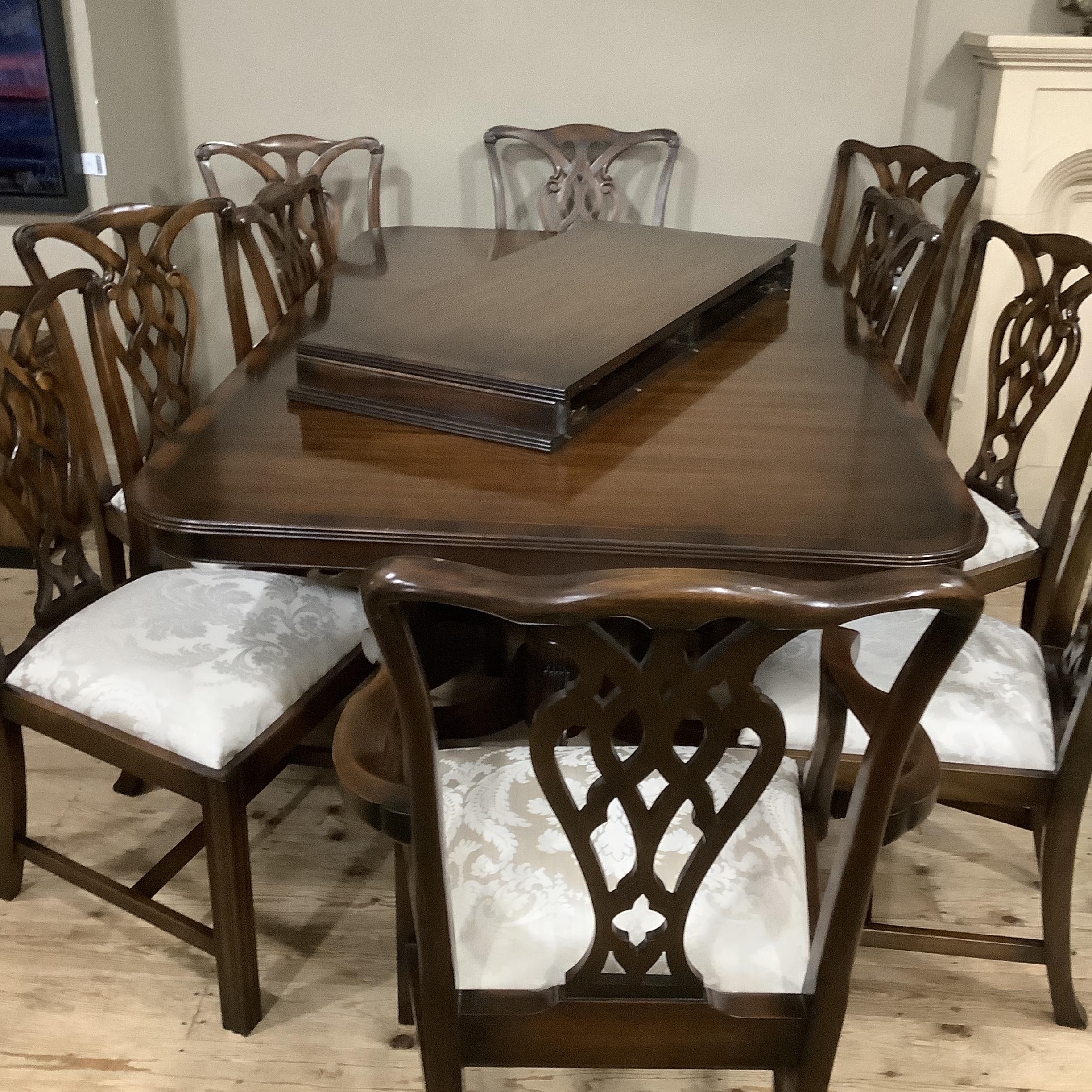 A Rackstraw dining room suite comprising extending dining table on twin pedestals each with three