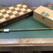 A game box with chequered outer surface, the interior lined in green baize together with a set of