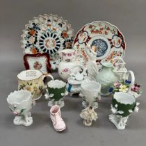 Two Imari plates, four continental flower encrusted egg cups on chicken feet, two trinket boxes