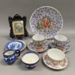 A pair of Japanese teacups and saucers and a larger plate, another cabinet cup and saucer, willow