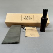 A Purdey fine turned lignum vitae duck caller in original carry bag and Purdey box