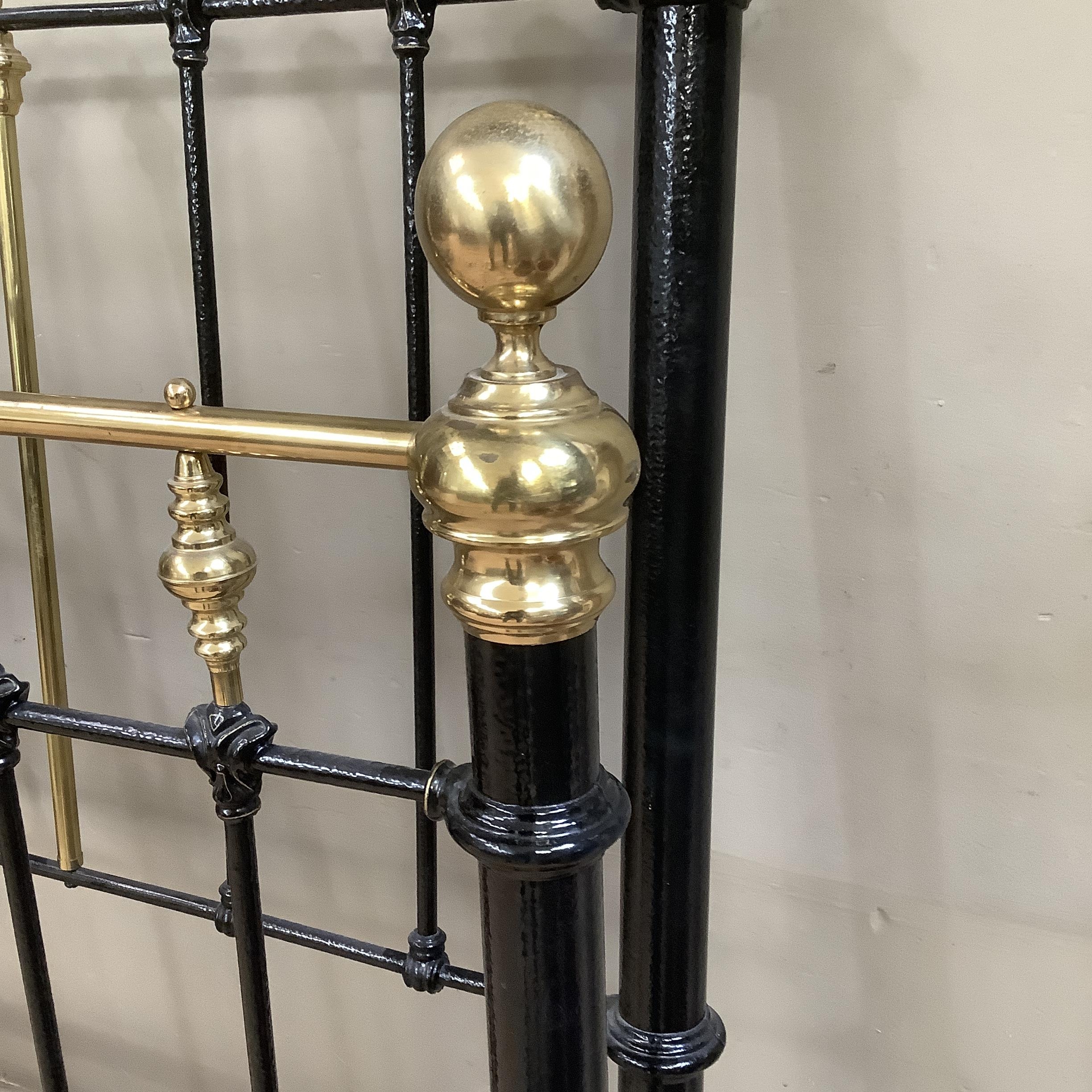 A Victorian brass and iron double bedstead with gallery rail and measuring approximately 5 feet by 6 - Image 2 of 3
