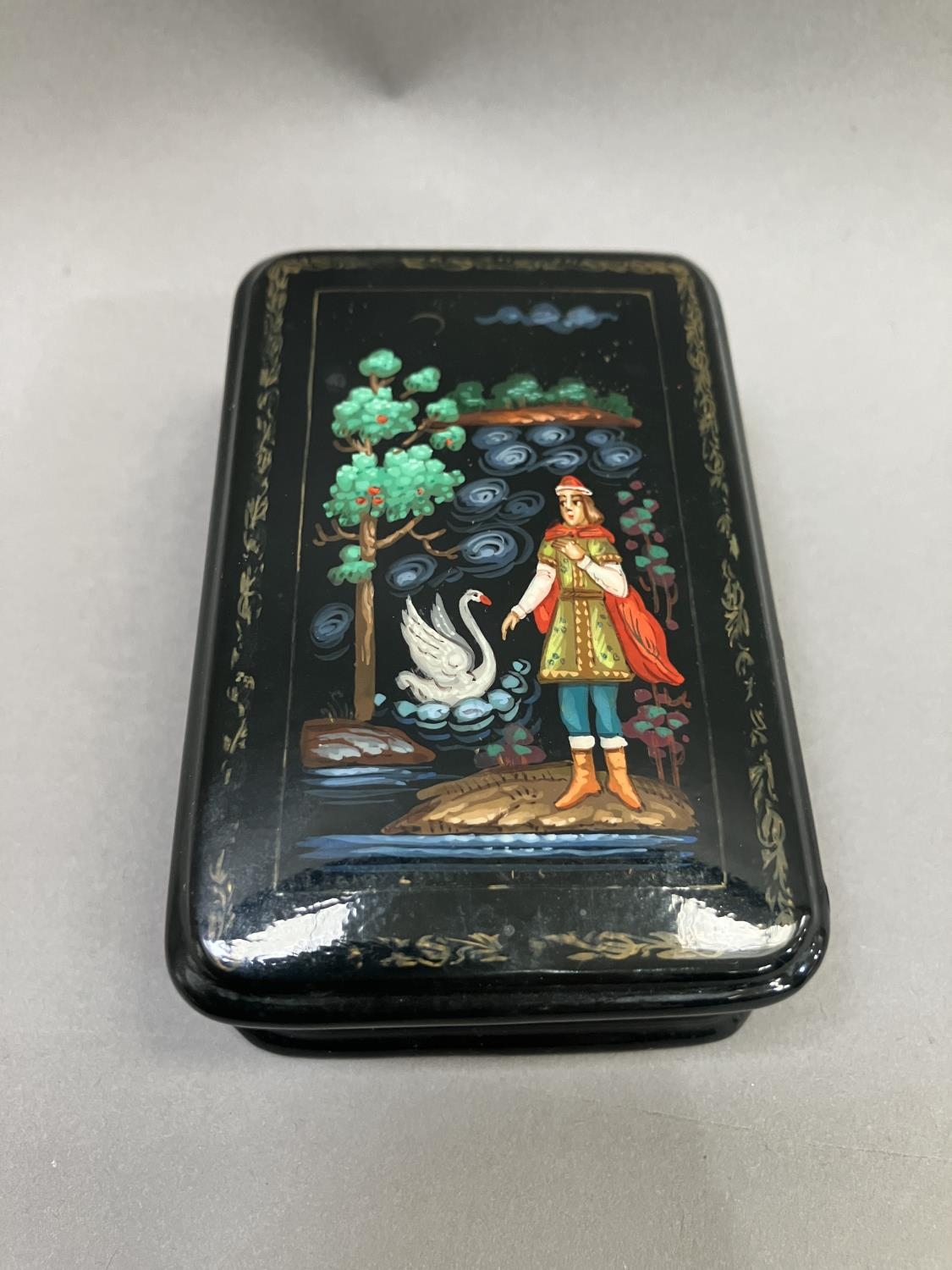 A Russian black lacquered trinket box, rectangular, the cover painted with a figure and swan, 8. - Image 5 of 5