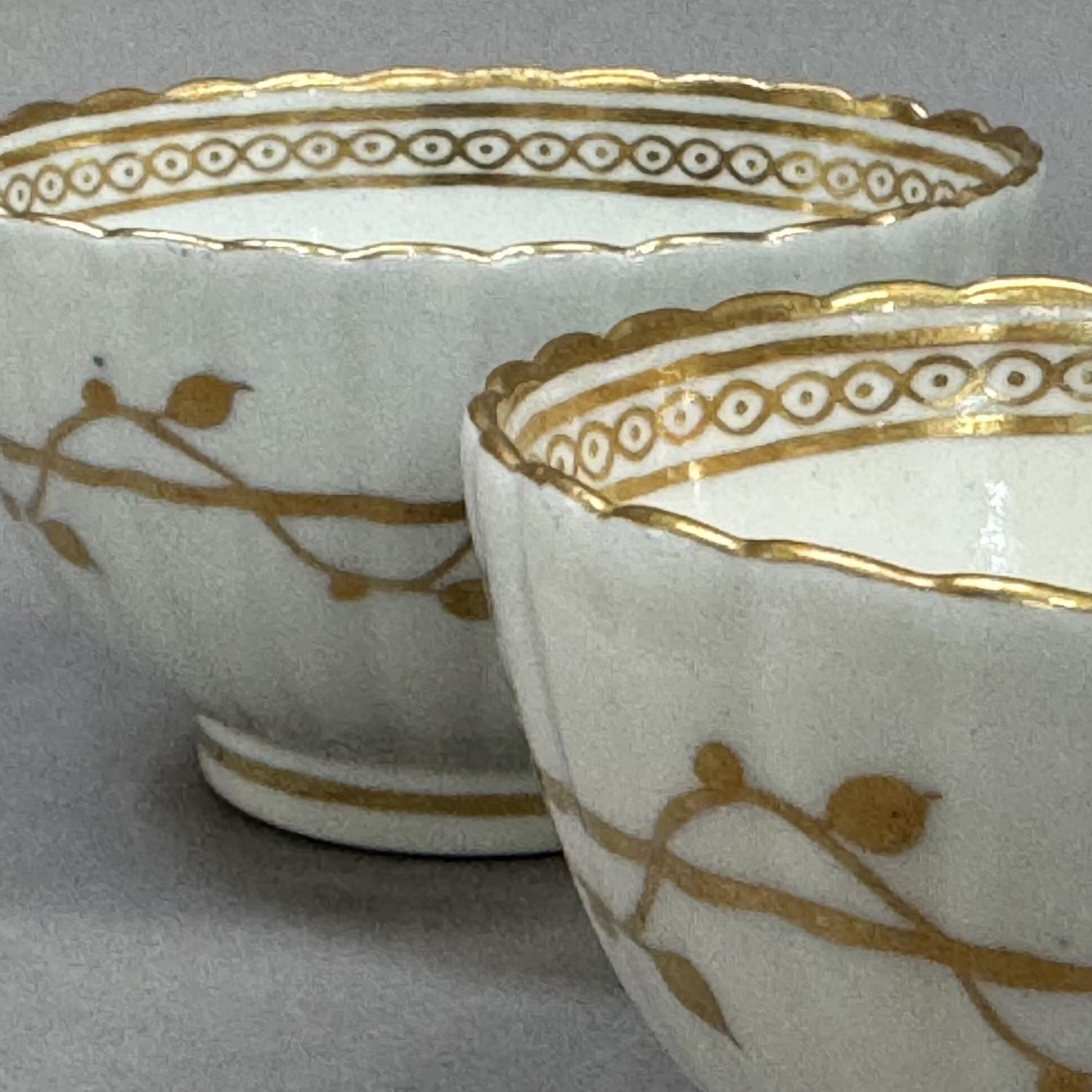 A pair of 18th century china tea bowls of fluted form decorated with a trailing vine to the exterior - Image 3 of 3
