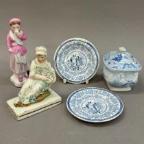 An early 19th century cream ware figure reclining on a rock with basket of fruit, on a cream