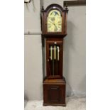 A reproduction mahogany longcase clock having an arched dial with moon phase, the chaptering with