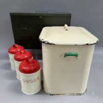 A document box, an enamelled breadbin, three enamel storage cannisters with red enamel lids