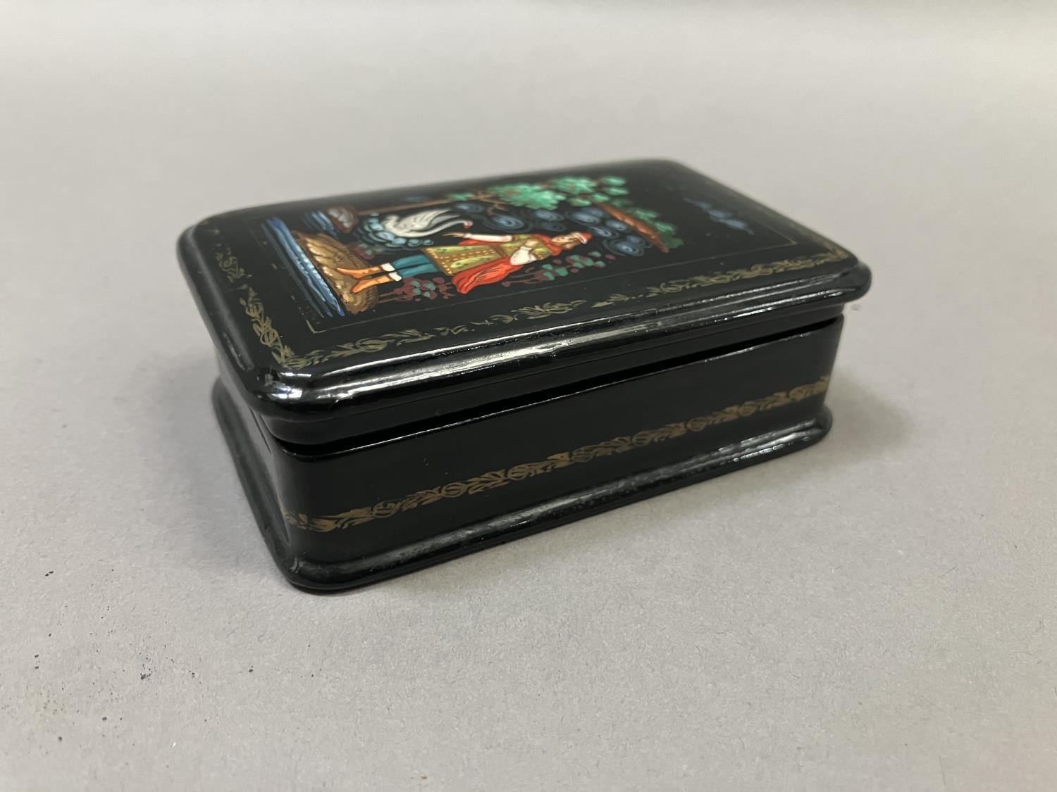 A Russian black lacquered trinket box, rectangular, the cover painted with a figure and swan, 8. - Image 4 of 5