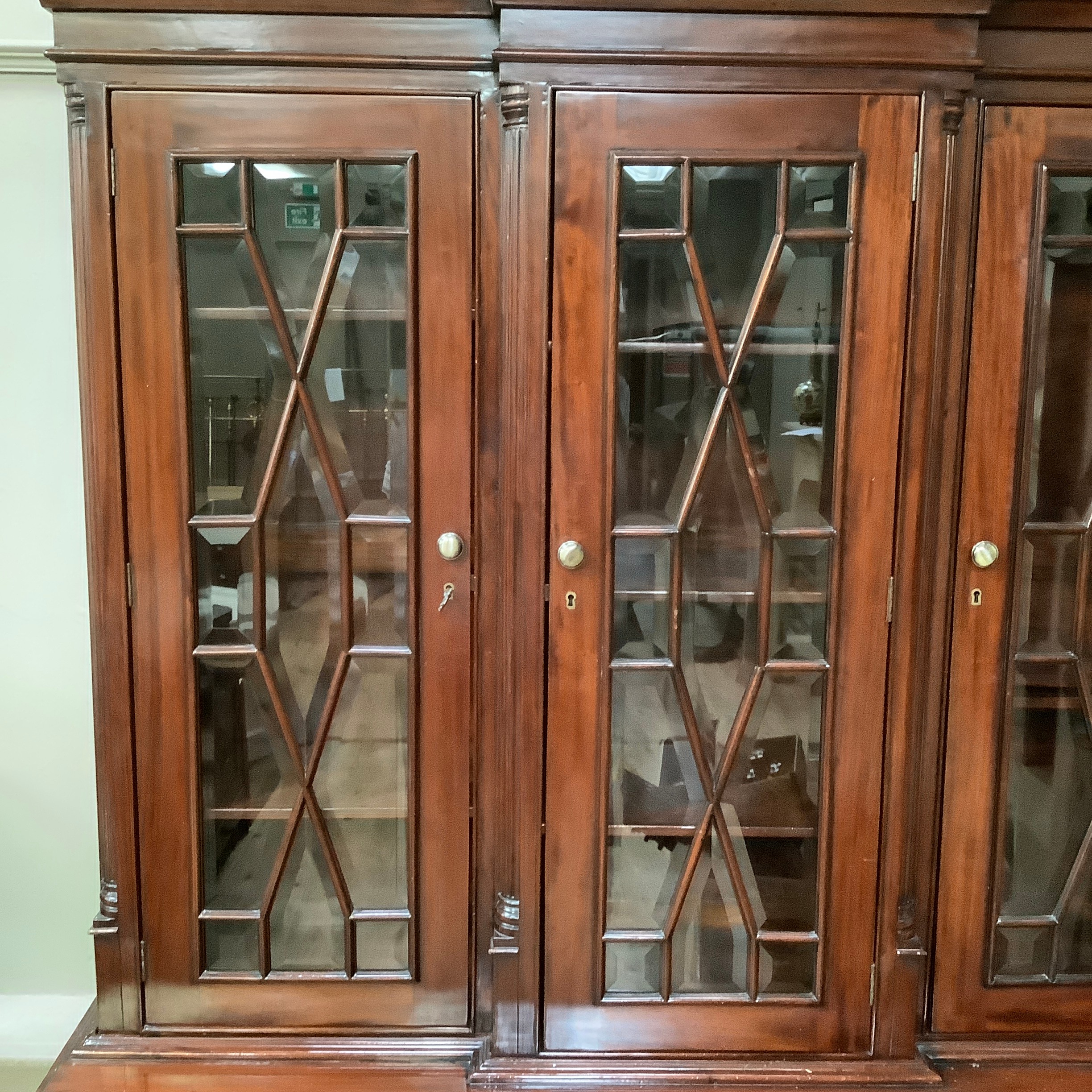 A reproduction 19th century style mahogany breakfront bookcase cupboard having a moulded cornice - Image 2 of 2