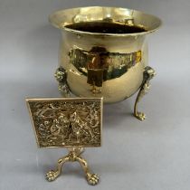 A brass miniature tilt-top tripod table, the panel cast in relief with monkeys, 15.5cm high,