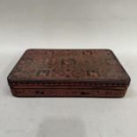 A Chinese black and iron red lacquered box, 30.5cm x 9.5cm x 5cm
