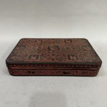 A Chinese black and iron red lacquered box, 30.5cm x 9.5cm x 5cm