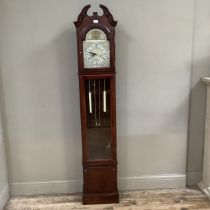 A reproduction longcase clock with arched dial, black Roman numerals, thirty-one day movement,