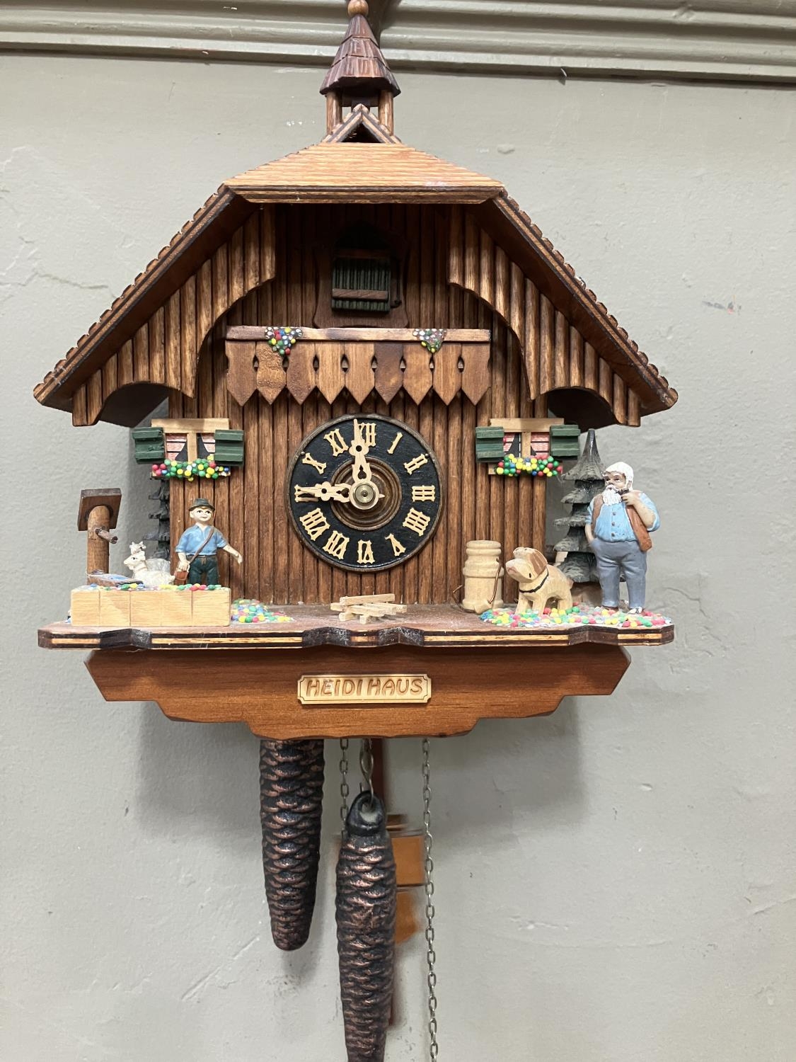 A Black Forest style cuckoo clock with swinging pendulum and weights having two figures , goats - Image 2 of 5