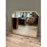 A gilt framed wall mirror with canted corners to the top, 110cm x 120cm