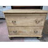 A Victorian pine chest of two deep drawers with later swing handles and associated turned feet, 95cm