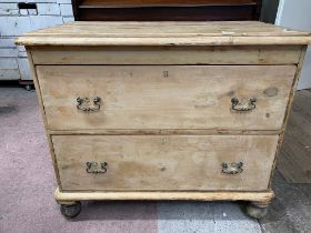A Victorian pine chest of two deep drawers with later swing handles and associated turned feet, 95cm