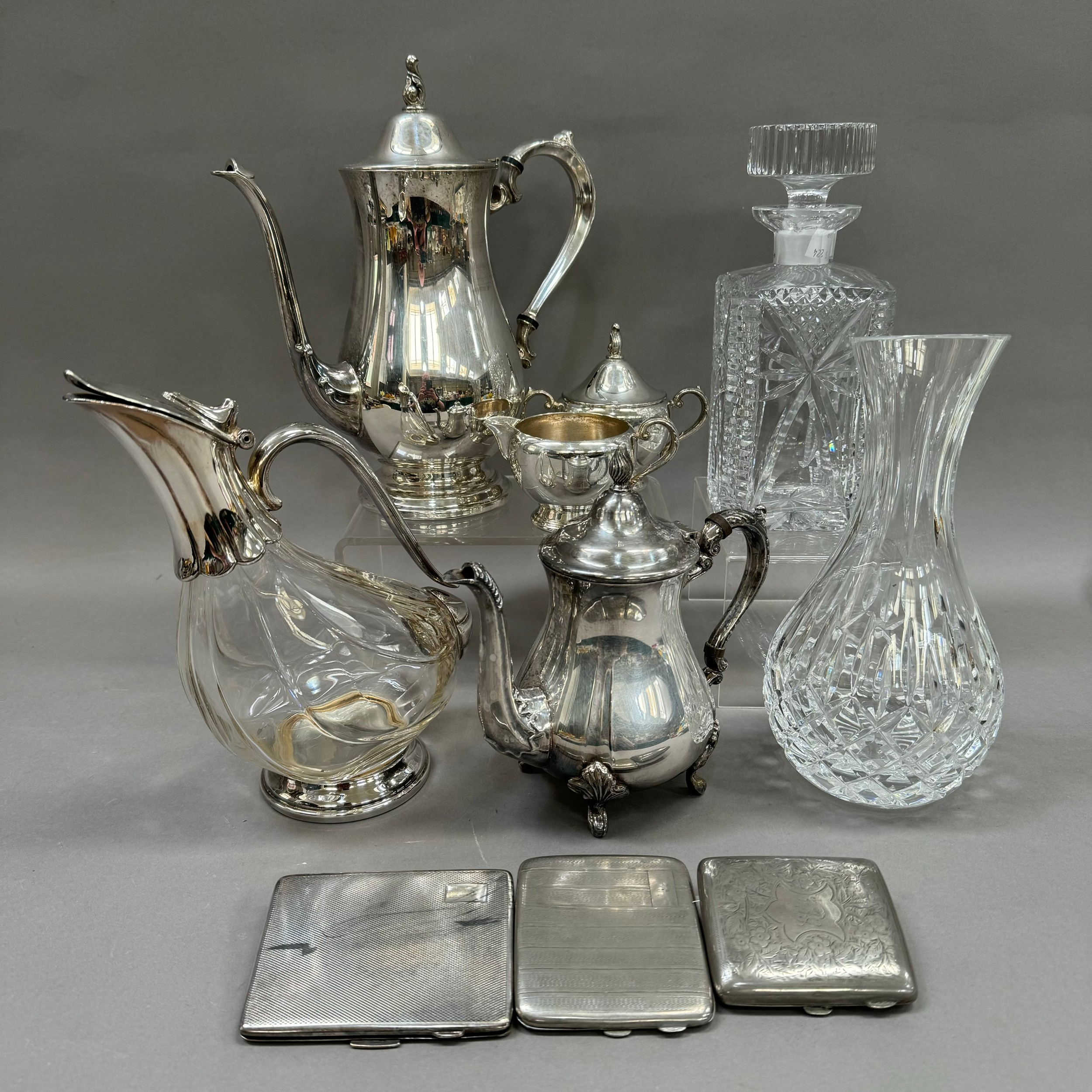 A three piece silver plated tea service and similar coffee pot, silver plated and glass wine