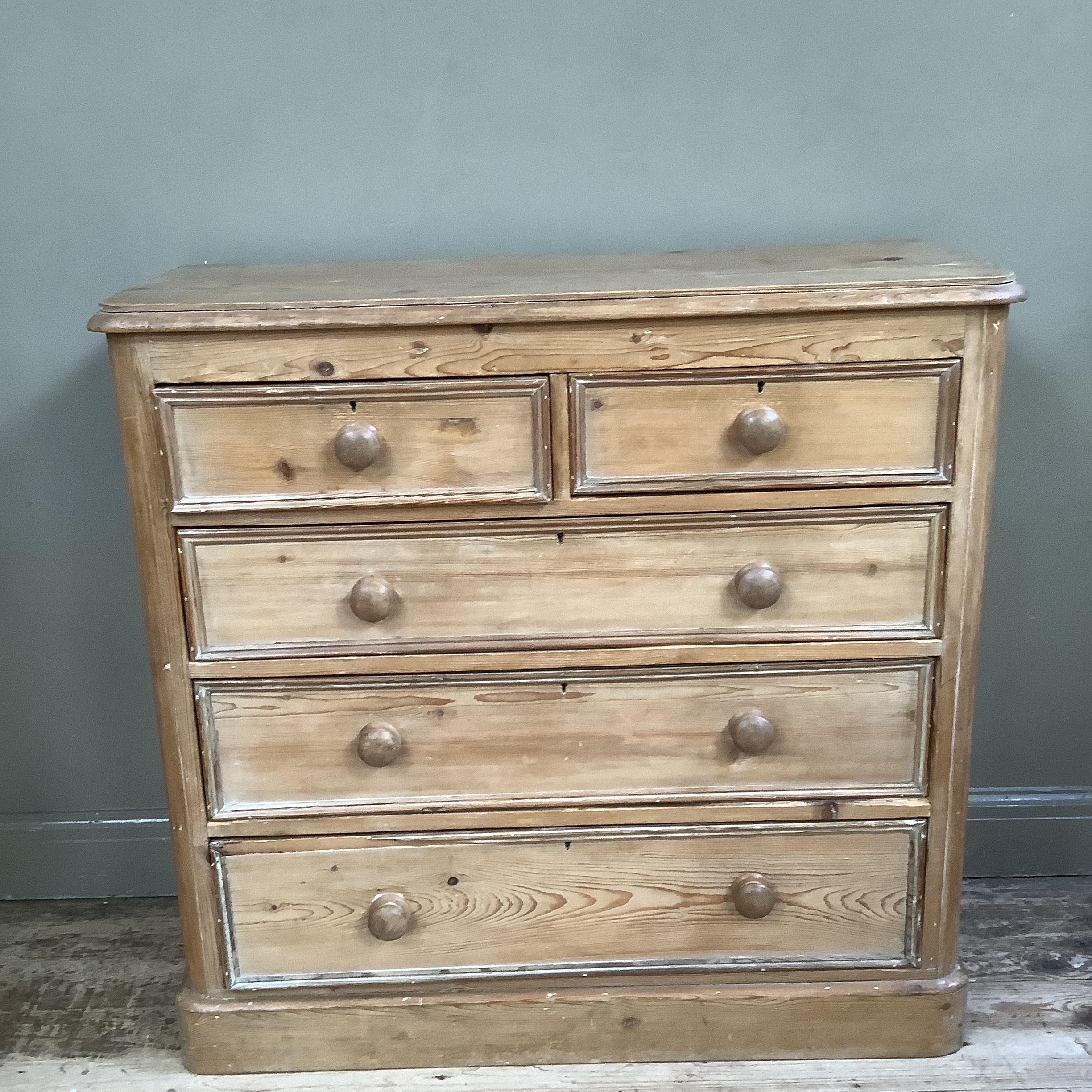 A Victorian pine chest of short and three long graduated drawers with later turned handles and