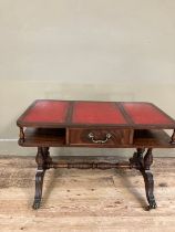 A mahogany and red leather incised coffee table having an under tier with drawer on turned refectory