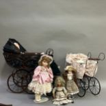 A collection of porcelain dolls with three Victorian style prams