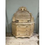 A Victorian stripped pine sideboard having an arched raised back with foliate pediment, two small