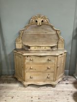 A Victorian stripped pine sideboard having an arched raised back with foliate pediment, two small