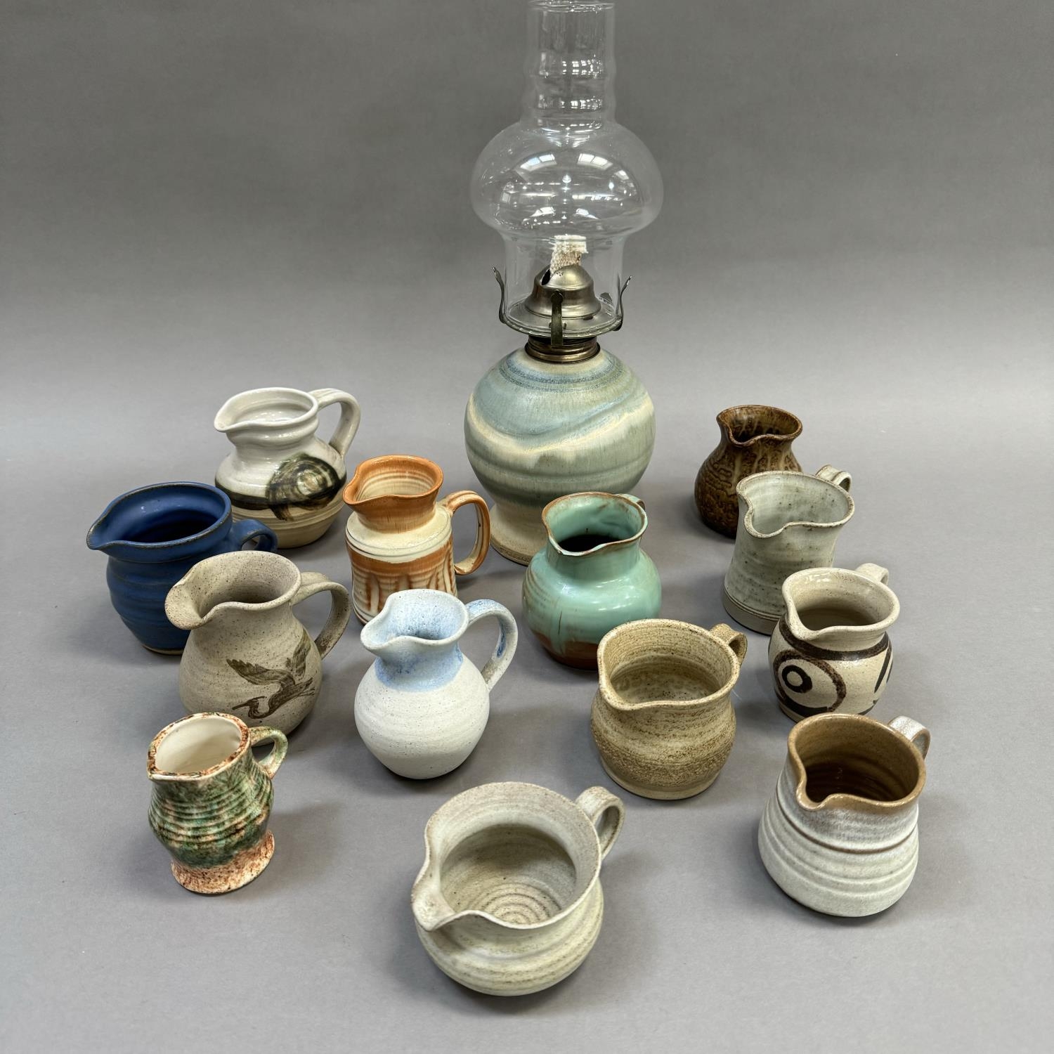 A collection of studio and other pottery jugs including Moffat Pottery Scotland, ,Riverstone,