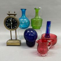 A collection of coloured glass including a carafe, ewer, float, sugar and cream, etc. together