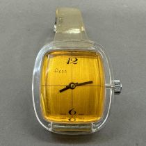 An Agor ladies' manual wristwatch in an oval clear perspex case, Swiss lever movement, rectangular