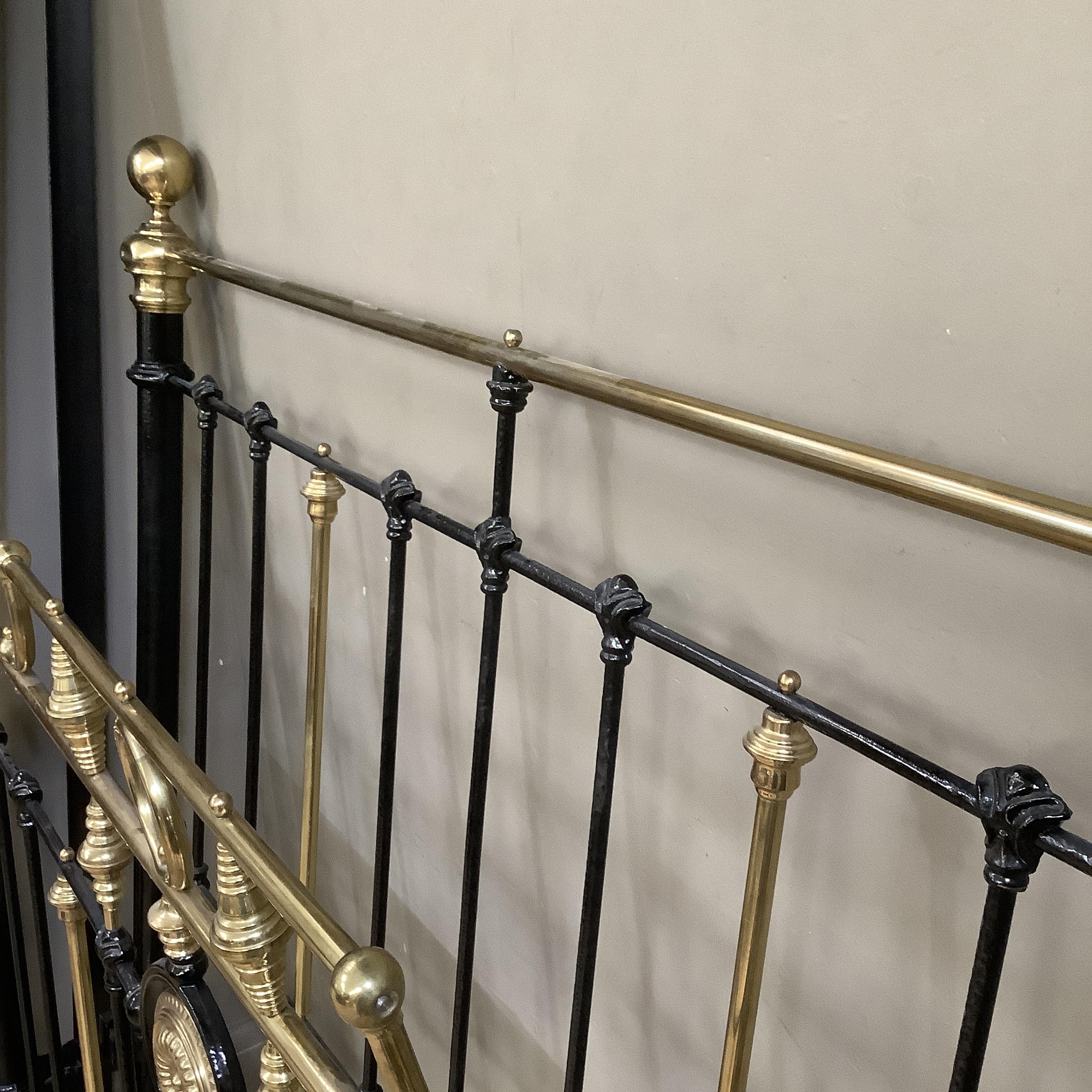 A Victorian brass and iron double bedstead with gallery rail and measuring approximately 5 feet by 6 - Image 3 of 3