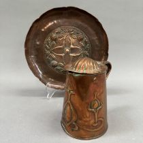 An Art Nouveau copper lidded jug embossed with stylised scrolling seed heads by J S & S,