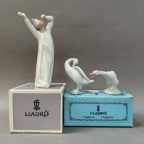 A Lladro figure of a boy in nightgown yawning together with a goose, boxed and a third goose unboxed