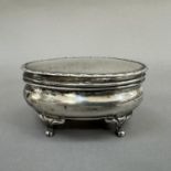 An Edward VII silver dressing table box, Birmingham 1907, of oval outline, with hinged top with