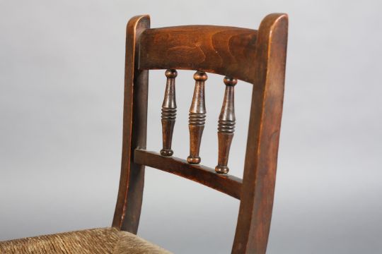 A 19TH CENTURY CHILD'S POLISHED BEECH CHAIR, having a bar top rail and triple spindle back, rush - Image 4 of 4