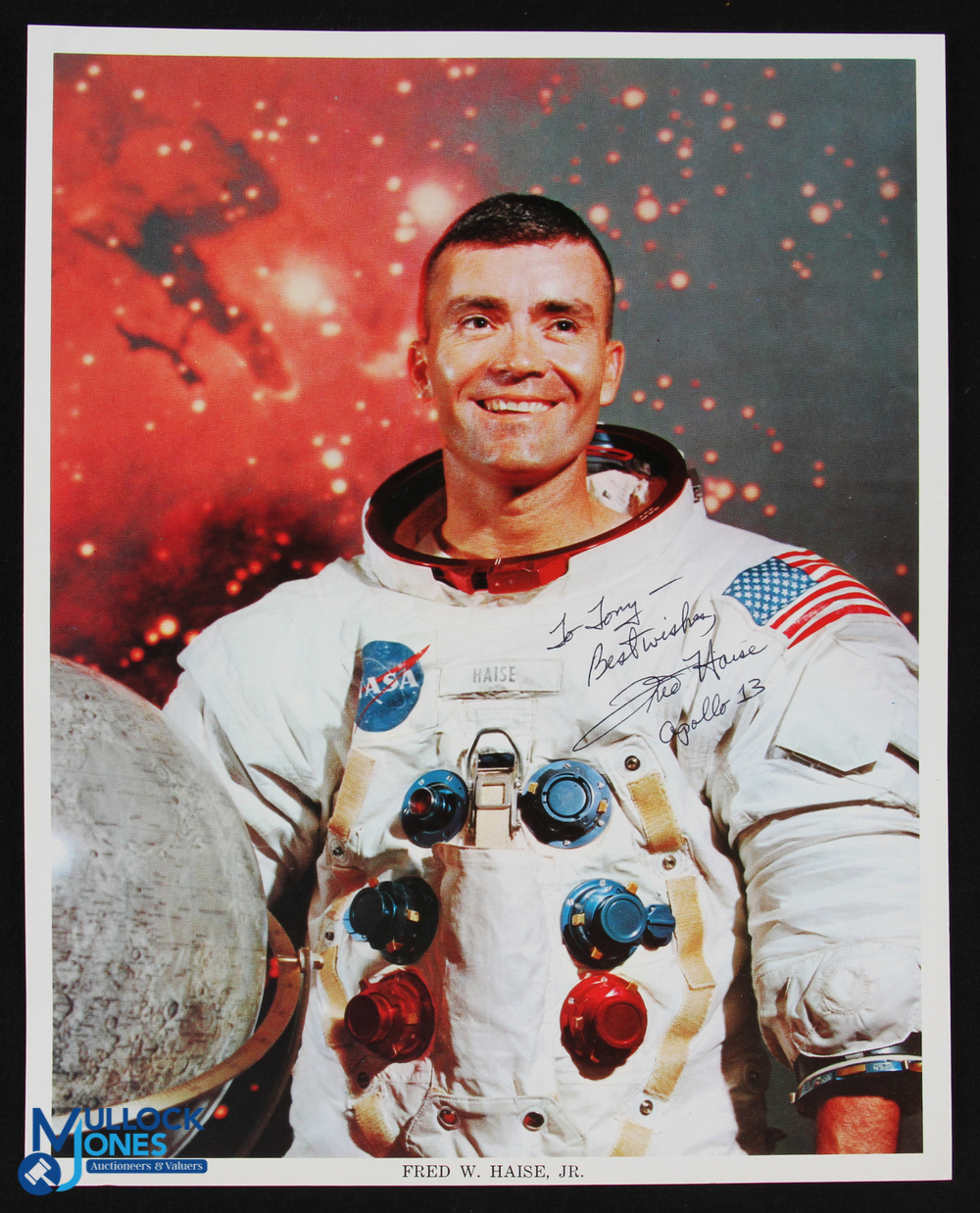 NASA - Charles Duke - Apollo 16 - colour 10x8 showing Duke seated in space suit signed across the - Image 2 of 2