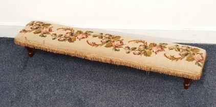 ELONGATED NEEDLEWORK PRAYER STOOL decorated with roses, on stout turned supports, 102cm long